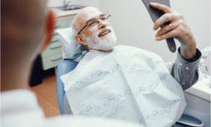 The senior patient has a successful dental treatment.